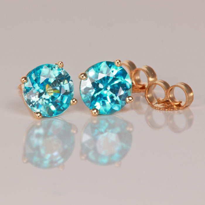 yellow gold and round blue zircon stud earrings