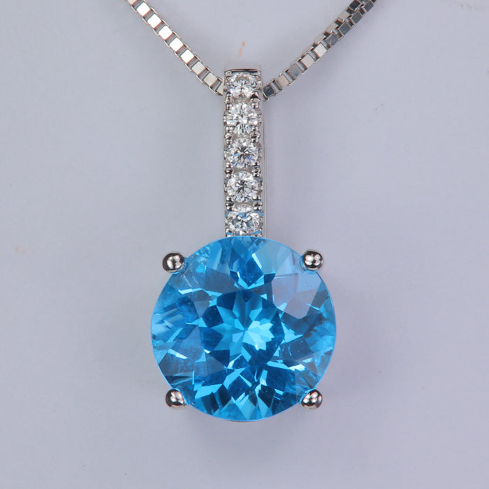 white gold blue topaz gemstone pendant with diamonds on the bail