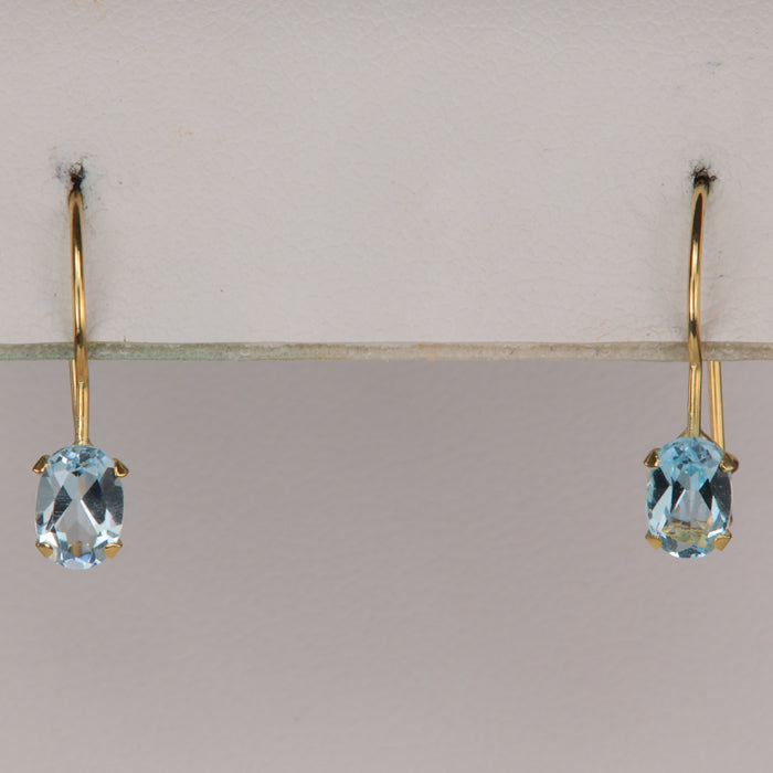 Yellow gold oval cut blue topaz earrings