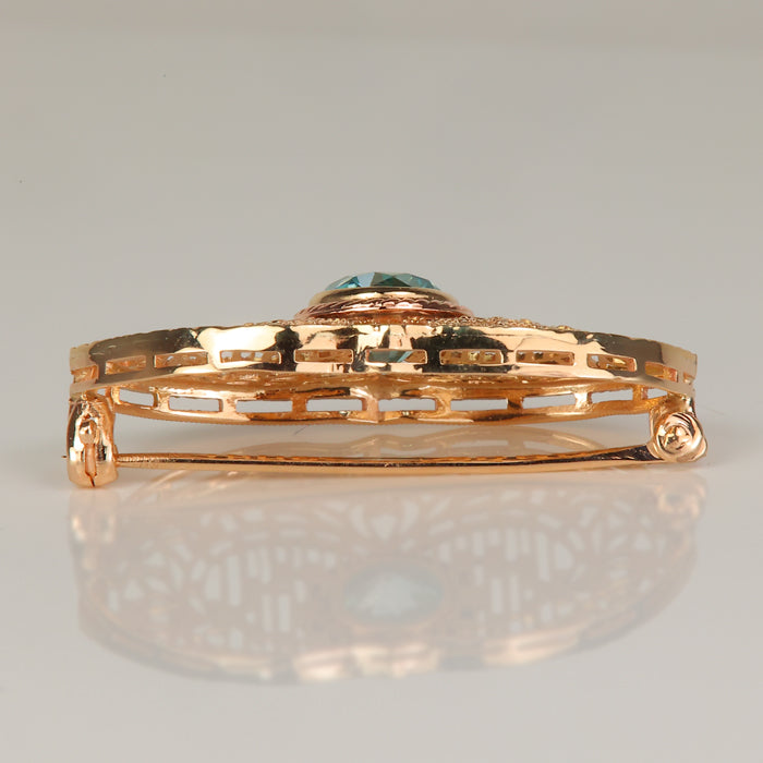 gold estate pin with blue zircon