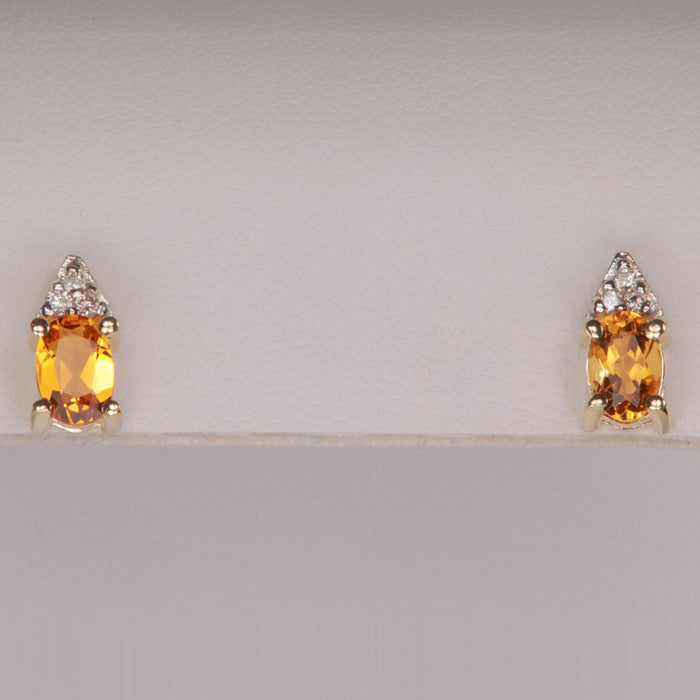 golden orange color citrine gemstone earrings with diamond in yellow gold