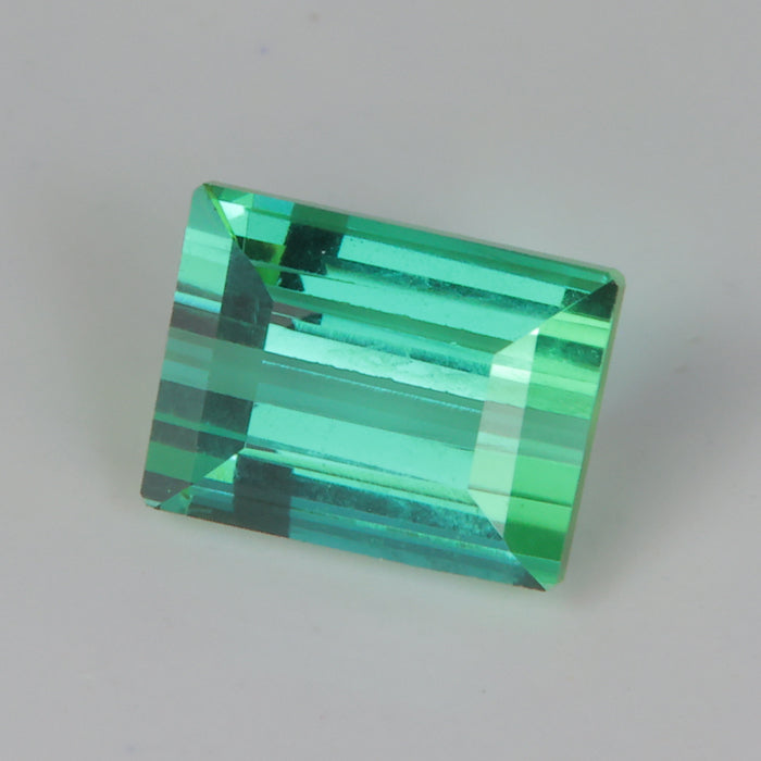 blue green emerald cut tourmaline gemstone