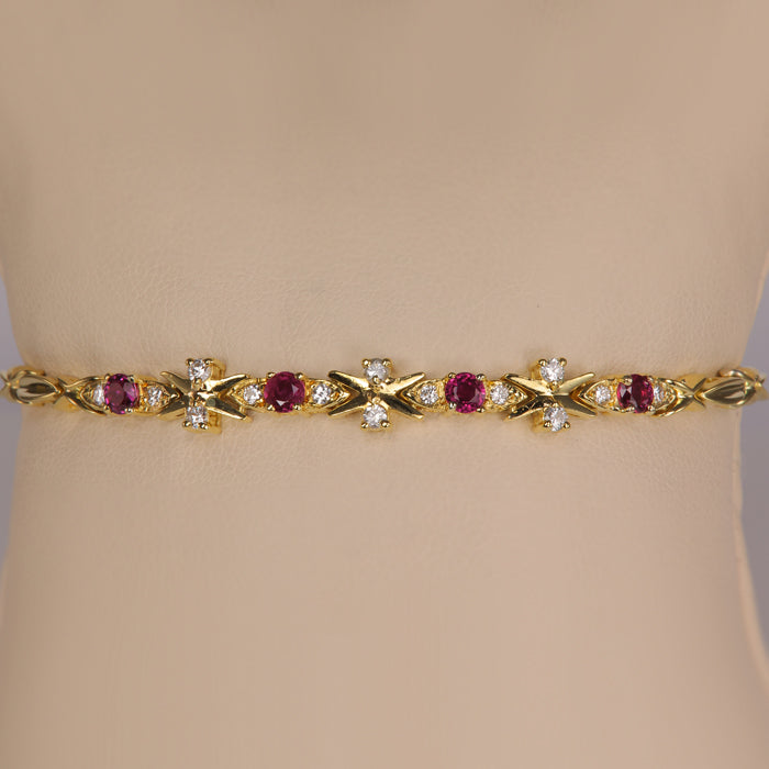 yellow gold bracelet with ruby gemstones and diamond accents 