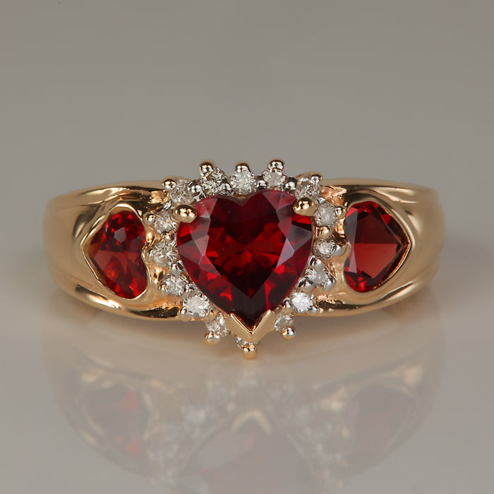 yellow gold ring with garnet hearts and diamonds 