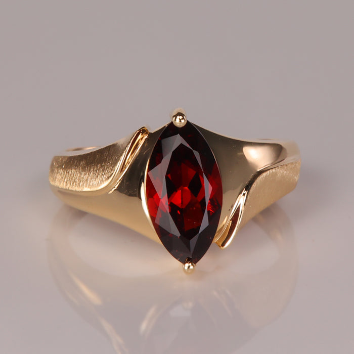 red color garnet gemstone ring in yellow gold