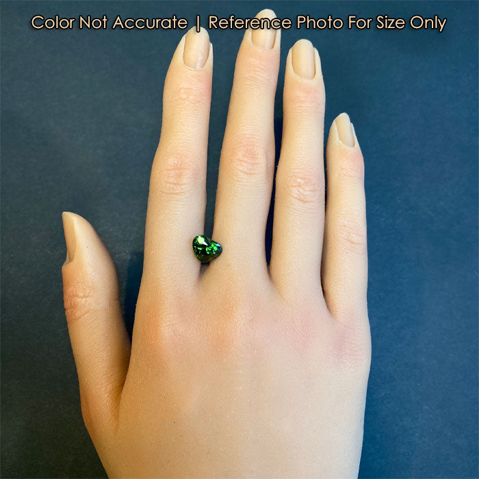 size of green zircon heart on a hand 