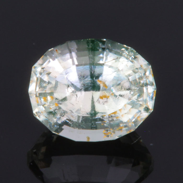 hyalite opal gemstone near colorless with daylight fluorescence stepped oval cut 