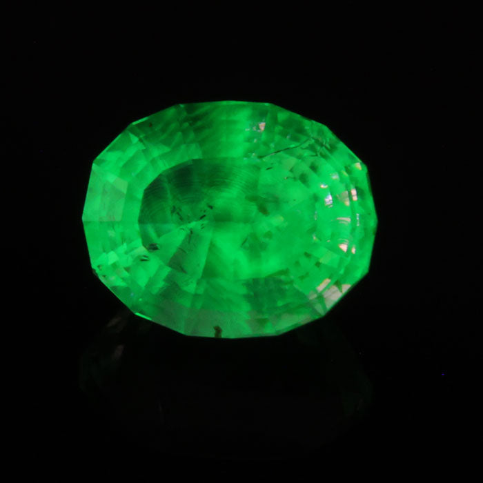 hyalite opal gemstone near colorless with daylight fluorescence stepped oval cut 