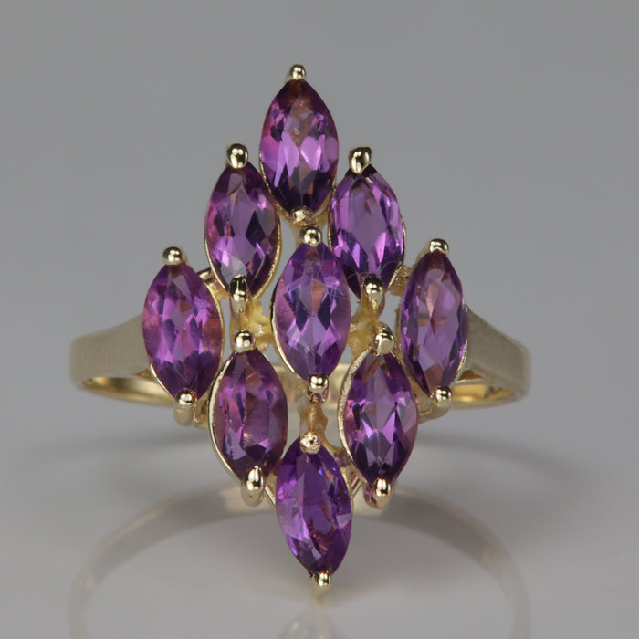 yellow gold ring with marquise cut amethyst gems