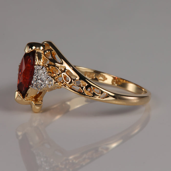 diamond accented garnet gemstone ring in yellow gold