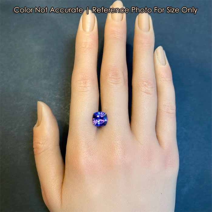 blue violet mixed cut tanzanite gem size to a hand