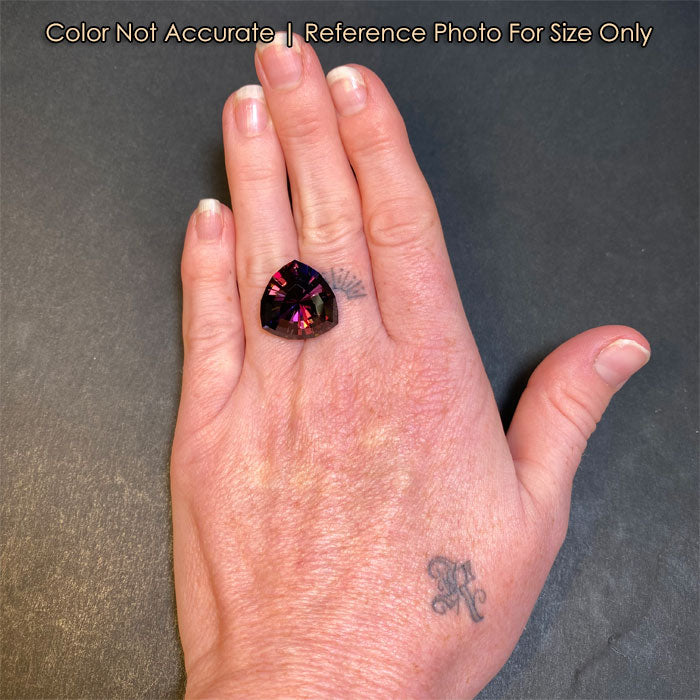 trilliant cut natural tanzanite on hand