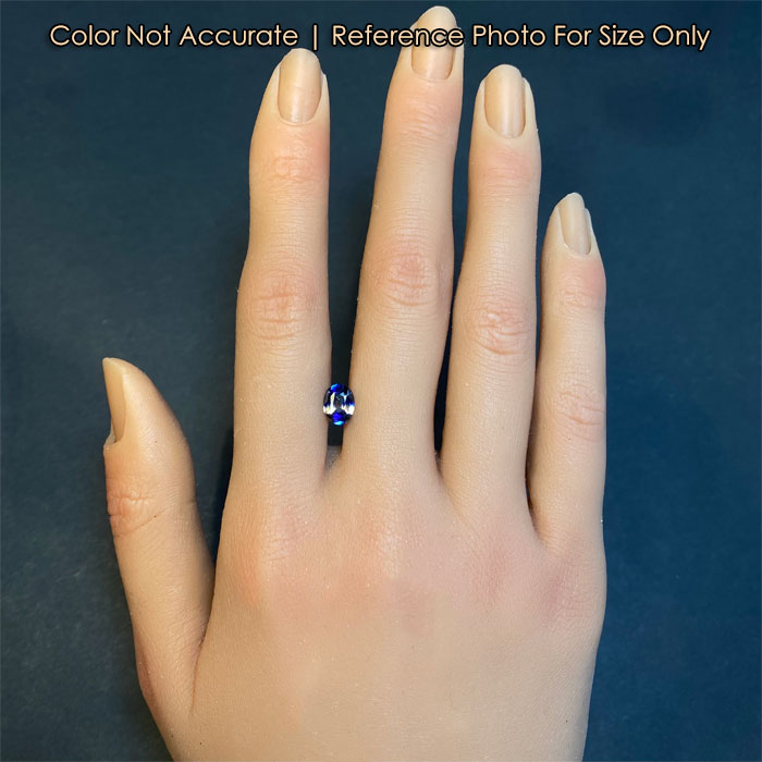 bicolor oval cut sapphire on hand