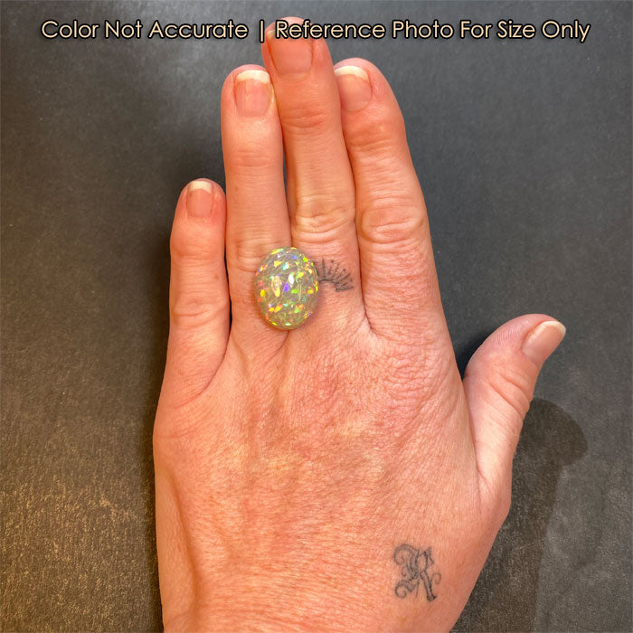 oval cut opal gemstone on hand