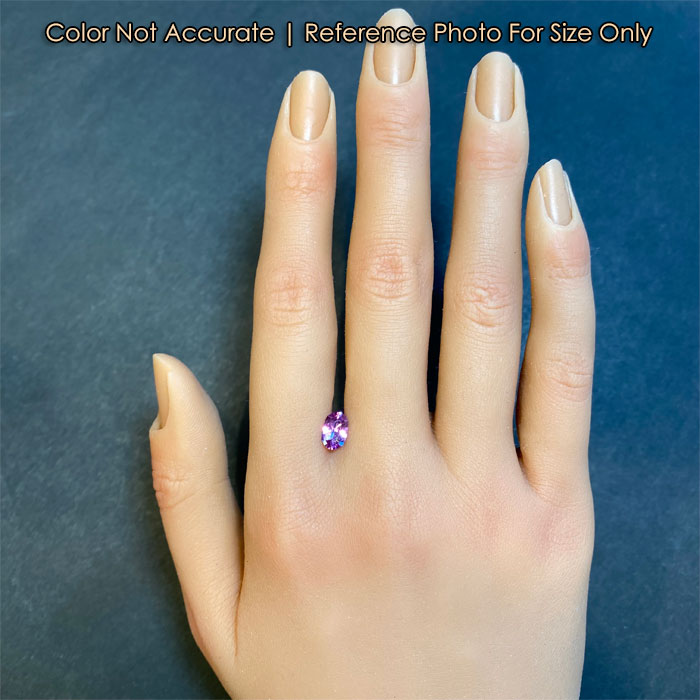 pink oval sapphire on hand