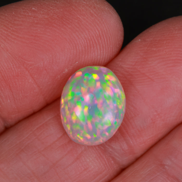 oval opal gem in hand
