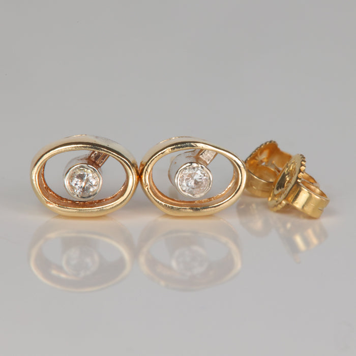 yellow gold oval shape stud earrings with bezel diamond accents