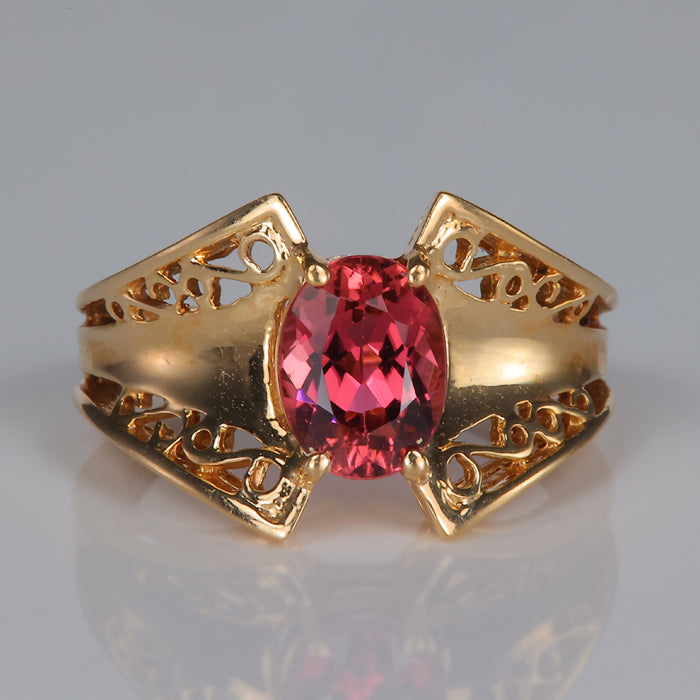 Oval cut pink tourmaline yellow gold ring