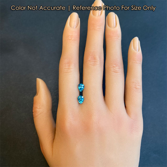 size of zircon gemstones on hand greenish blue color