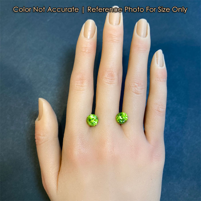 fine green peridot pair size to hand
