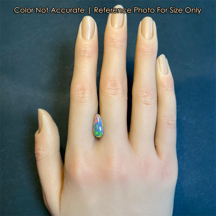 pear shape black opal gem on hand