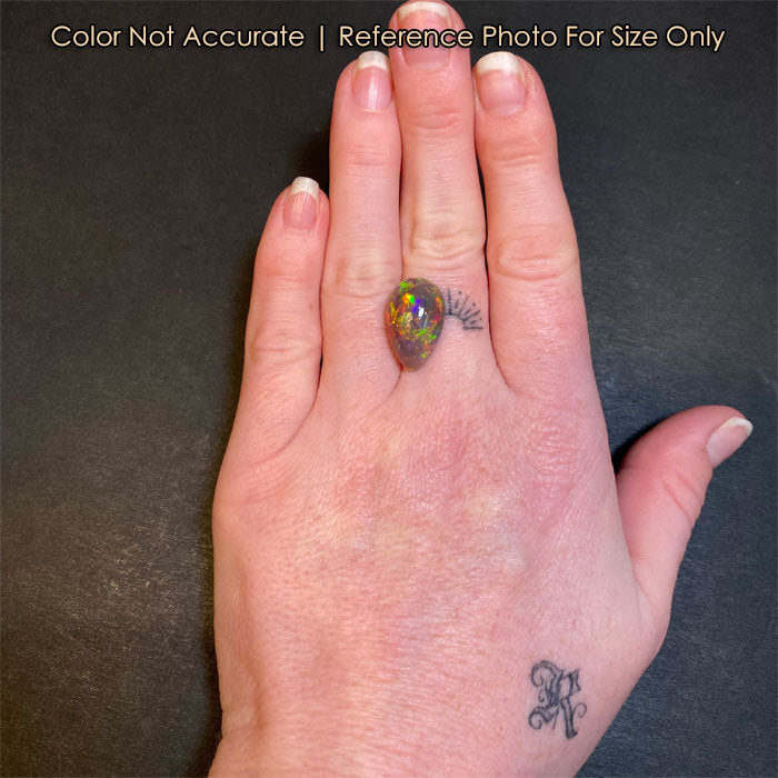 pear shape opal gem on hand