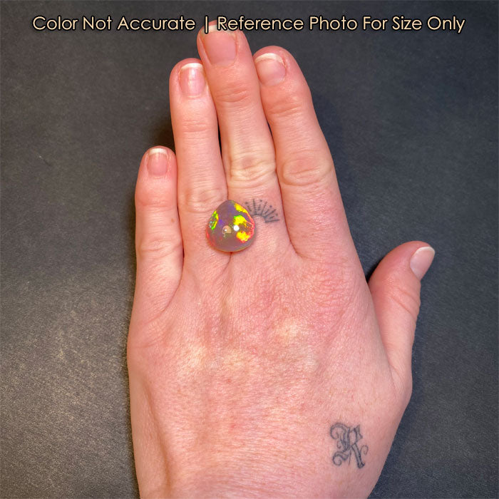 size of pear opal gemstone to a hand