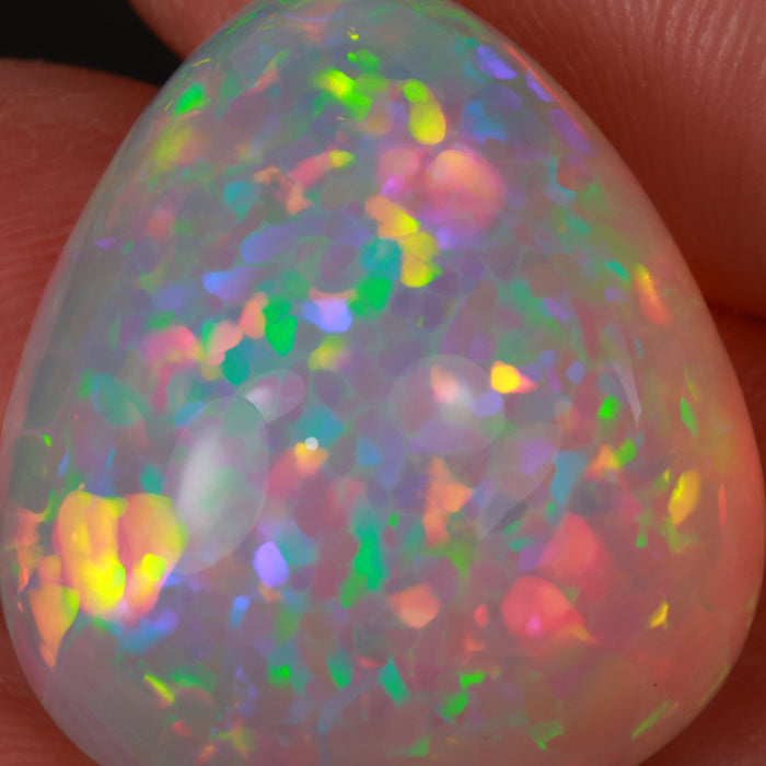 large pear opal gemstone in hand
