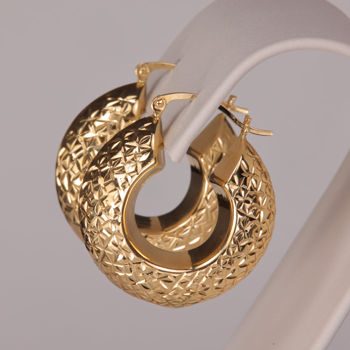 diamond cut design on puffy style hoop earrings in yellow gold 