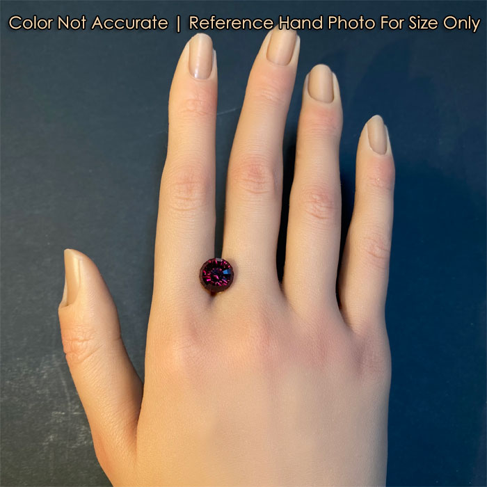 round portuguese cut garnet gemstone on hand