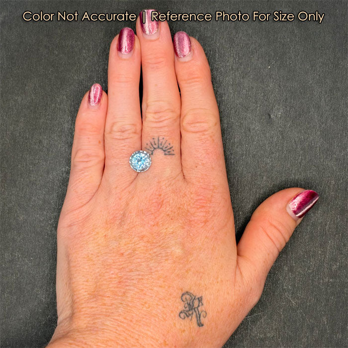 blue aquamarine gemstone on hand