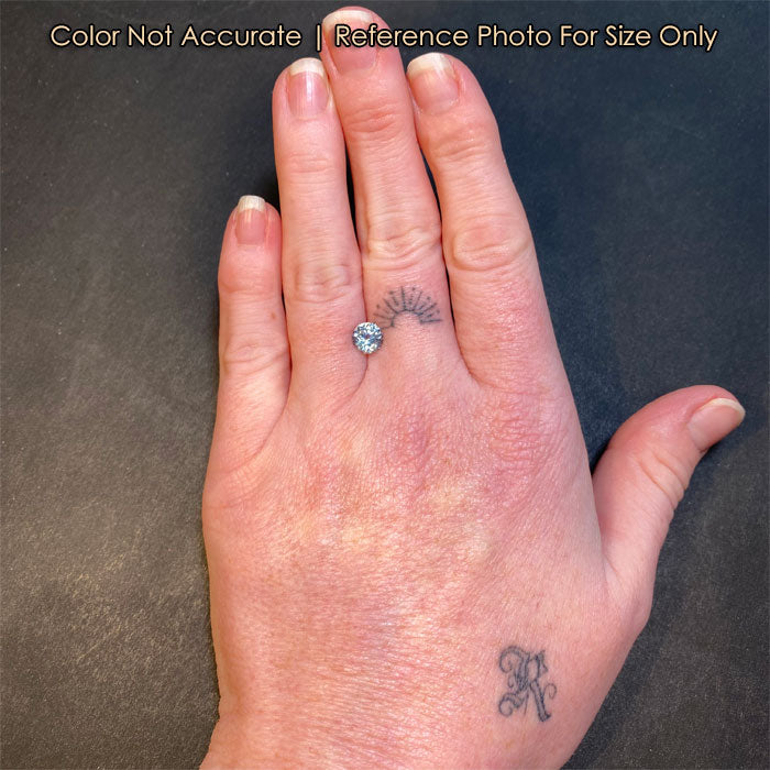 blue round brilliant sapphire on hand