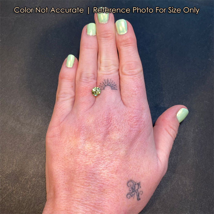 light green natural sapphire gemstone on hand size 