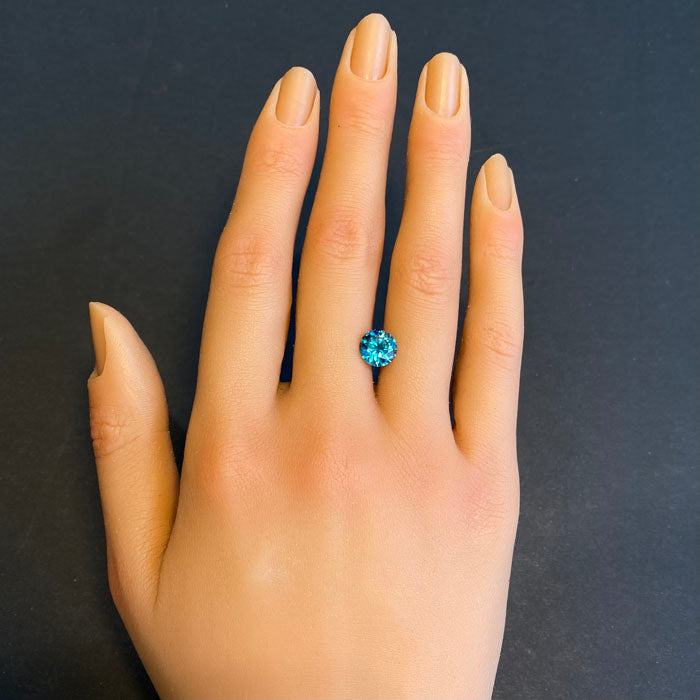 greenish blue round brilliant zircon gem
