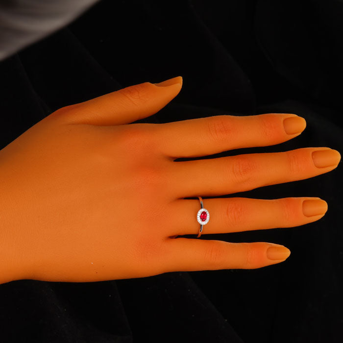 Ruby Oval Ring on hand with diamonds around