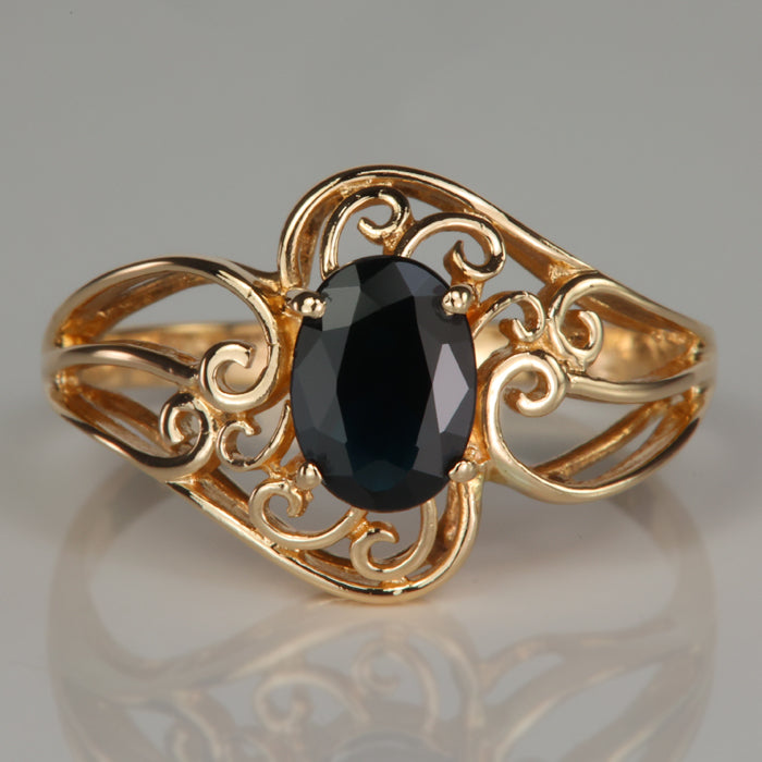 yellow gold filigree design ring with oval cut sapphire gemstone