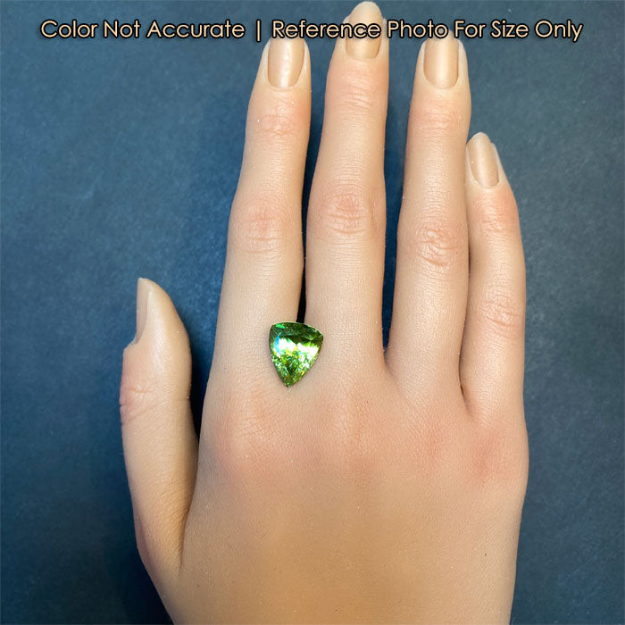 green color sphene gem on hand for size