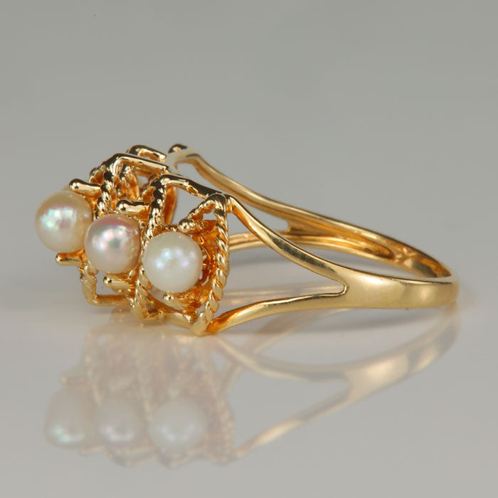 side of twist style gold ring with pearls