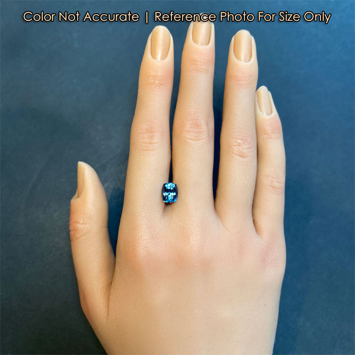 blue color spinel gem on hand