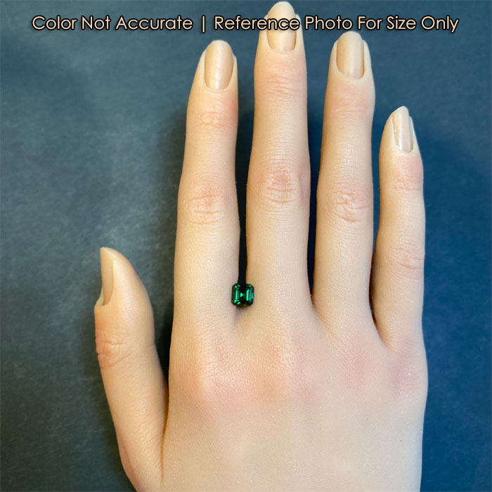 green tsavorite garnet gem on hand