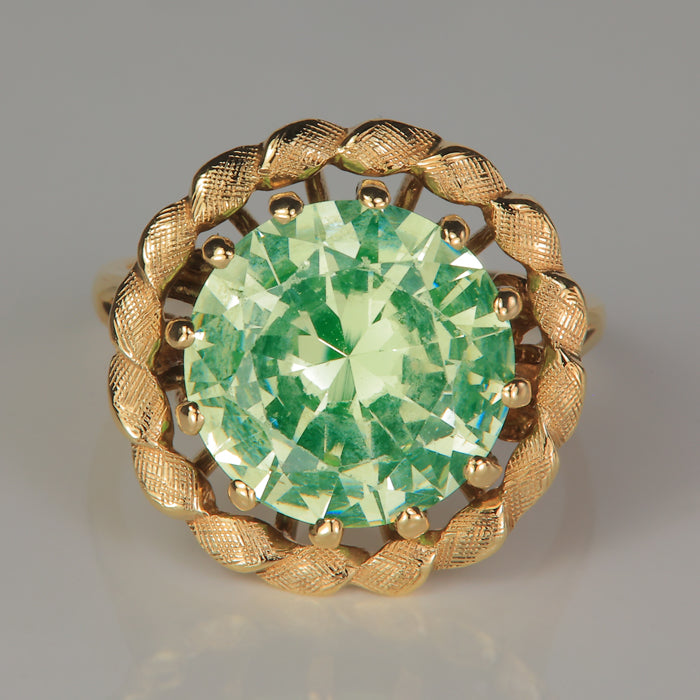 yellow gold crosshatch patterned ring with green synthetic spinel gemstone 