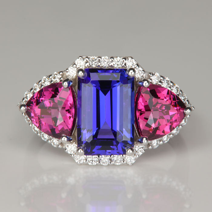 blue violet tanzanite gemstone ring with umbalite garnets and diamonds in white gold