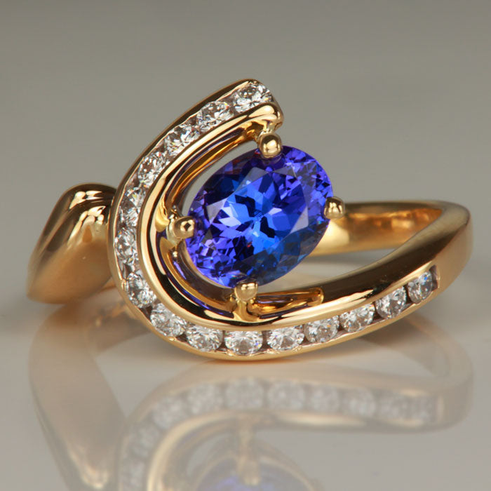 oval tanzanite and channel set diamond ring in yellow gold