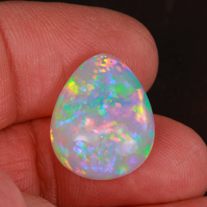 pear cabochon opal in hand from ethiopia