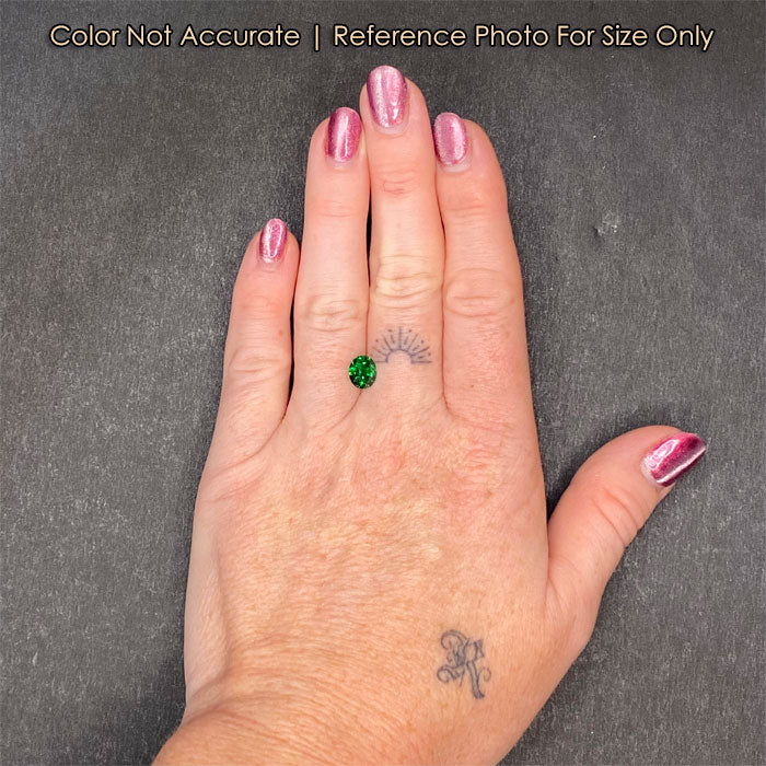 green oval tsavorite on hand 