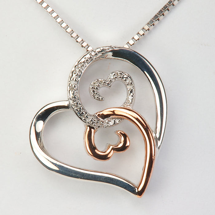 sterling silver and rose gold estate heart pendant with diamonds