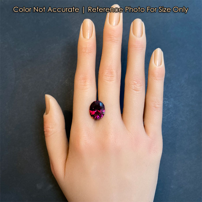 size of oval umbalite garnet gem on hand