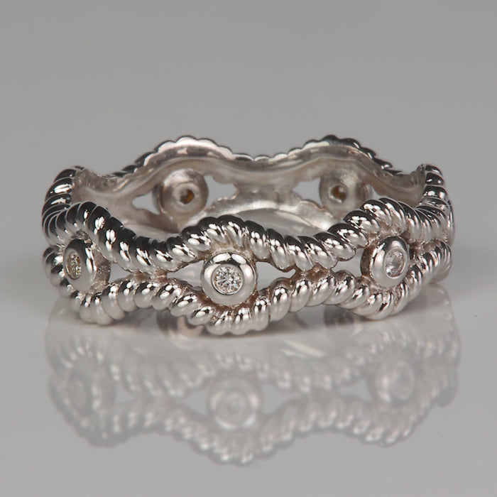 white gold ring wave shape with bezel set diamonds