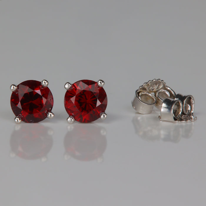 round brilliant pyrope garnet gemstone stud earrings in white gold