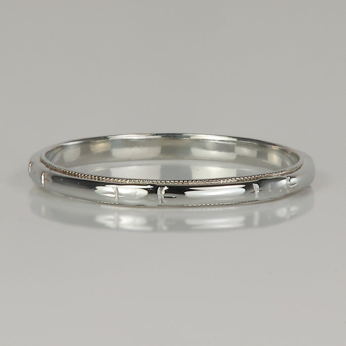millgrain and diamond cut detail in white gold ring